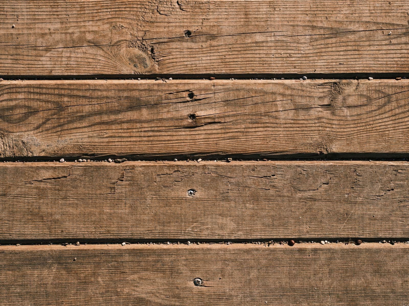 Close view of brown wood deck boards and nail heads